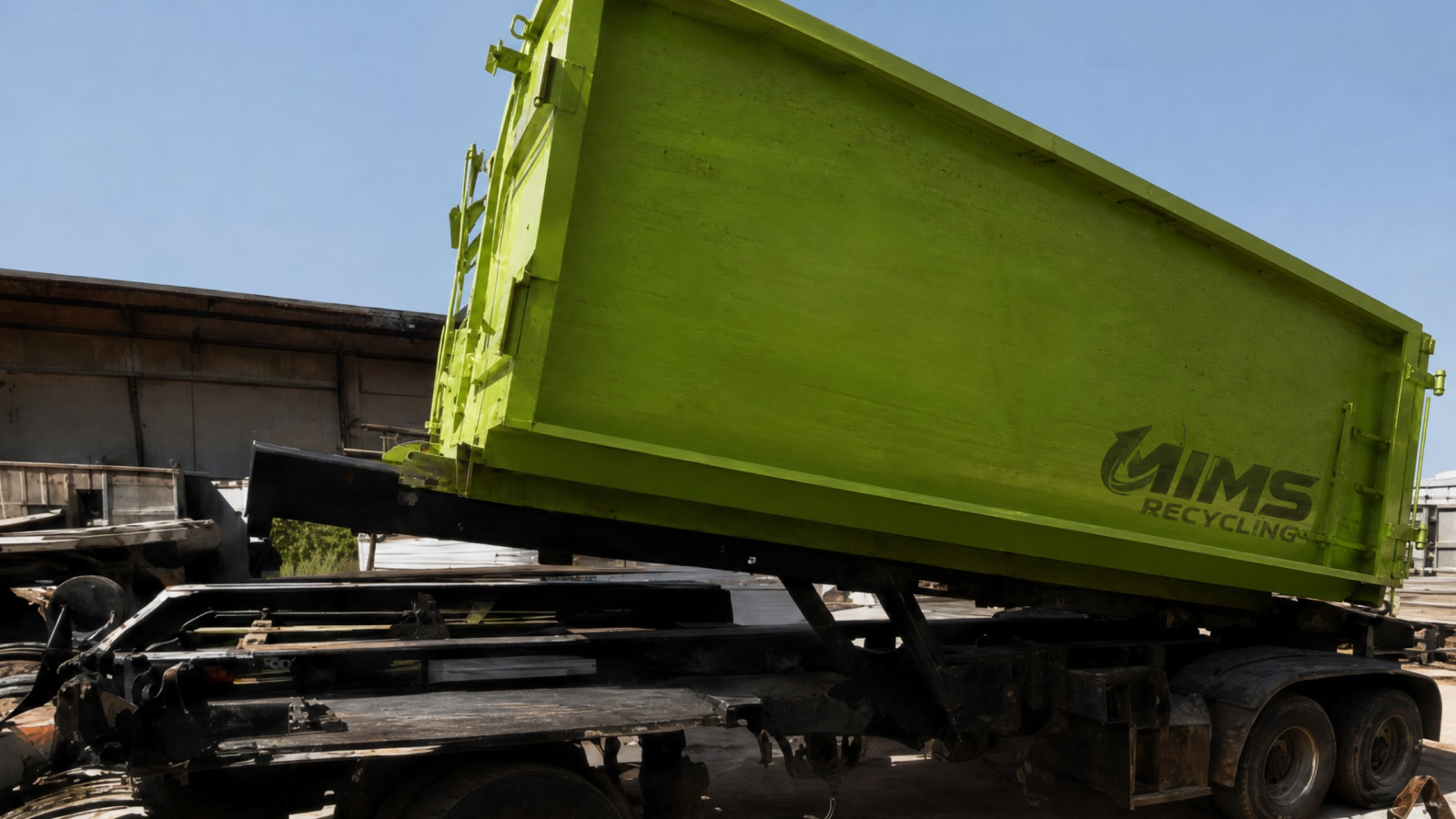 A green Mims Recycling rolloff container