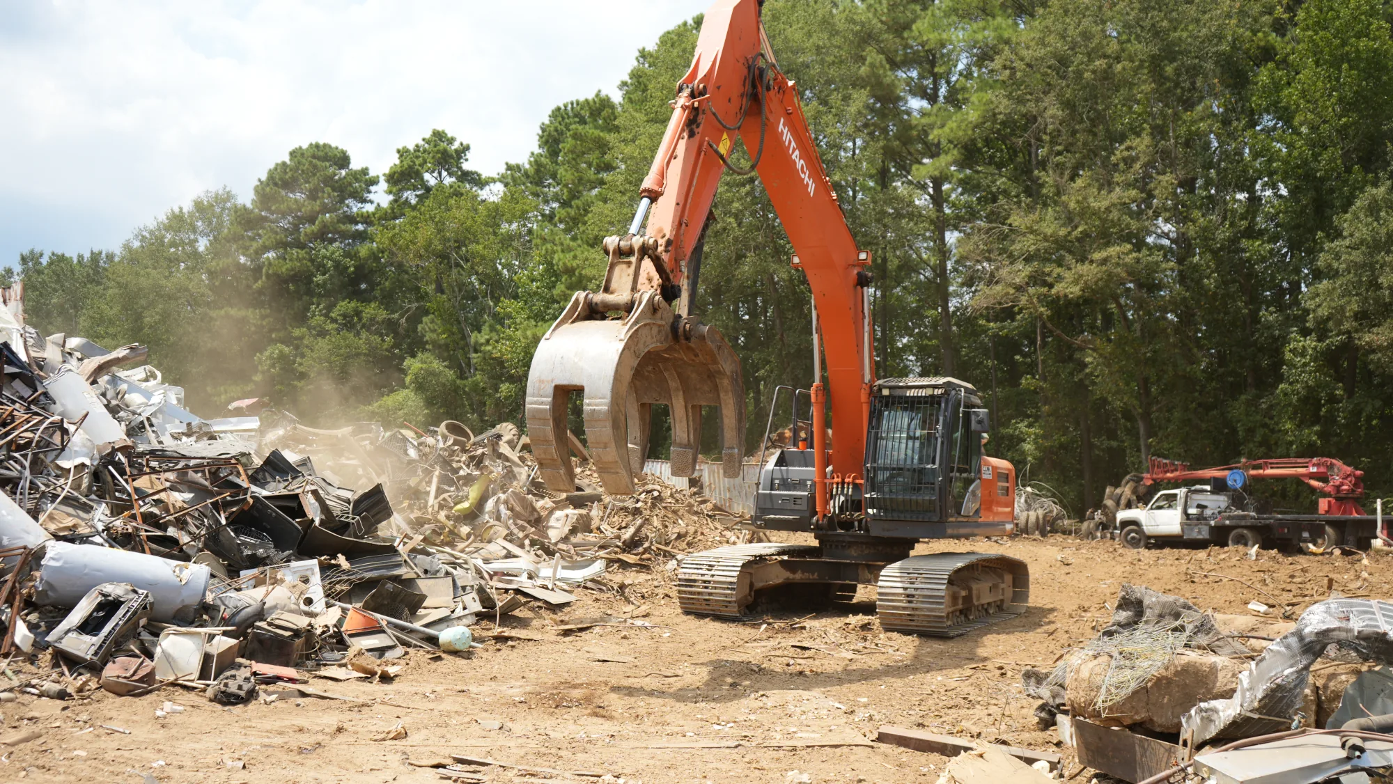 A Mims Recycling excavator sorting material in the scrap yard